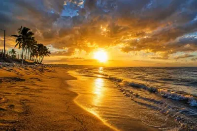 La orilla al atardecer, con las olas recibiendo la última luz