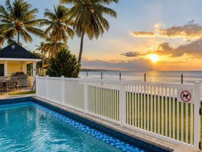 La piscina compartida al amanecer, con el mar detrás de la verja